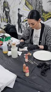 Tattoo training participant practising at a workstation